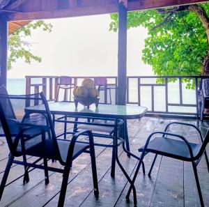a table with chairs and a teddy bear sitting on it at LOwayalailaiSTAY in Wayasewa Island
