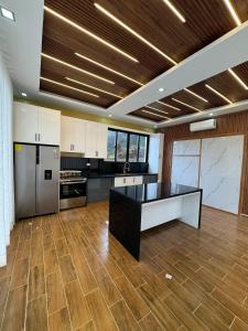 a large kitchen with a black and white counter top at Las Indgenas 6BR Pool Jacuzzi Gazebo in Imbert