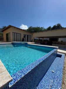 a swimming pool in front of a house at Las Indgenas 6BR Pool Jacuzzi Gazebo in Imbert