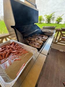 a grill with a bunch of sausages and other foods at Las Indgenas 6BR Pool Jacuzzi Gazebo in Imbert