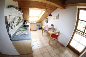 an overhead view of a kitchen with a table at Christina's Bergblick in Oberammergau +4 photos