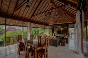 a dining room and kitchen with a table and chairs at Villa Campania in Blahbatu