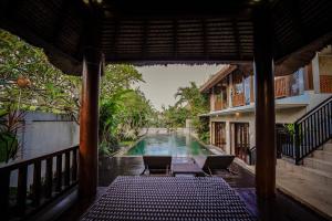 a view of a swimming pool from the porch of a house at Villa Campania in Blahbatu