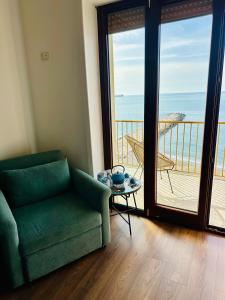 a living room with a couch and a view of the ocean at BluMare ArtHouse in Salerno