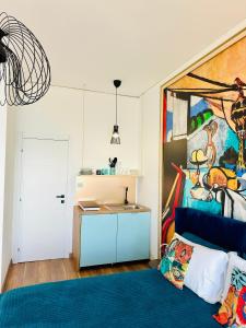 a room with a bed and a painting on the wall at BluMare ArtHouse in Salerno +78 photos