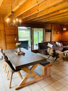 a living room with a table and a couch at La cabane du Cerf in Stavelot