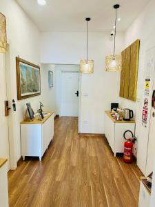 an office with two desks in a room with wooden floors at BluMare ArtHouse in Salerno