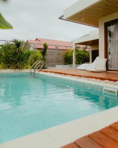 a swimming pool in front of a house at Villa Kaiyo La Union in Bacnotan