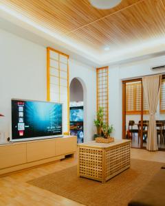 a living room with a large flat screen tv at Villa Kaiyo La Union in Bacnotan