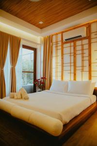 a large bed in a room with a window at Villa Kaiyo La Union in Bacnotan +20 photos