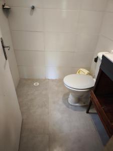 a small bathroom with a toilet and a sink at Chalé no Plantar em Casa in São Roque +18 photos