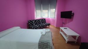 a bedroom with a white bed and pink walls at Hotel Aro'S in Casas Ibáñez