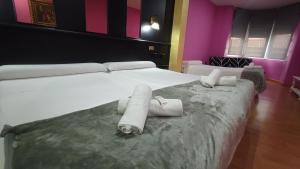 a bedroom with a large bed with towels on it at Hotel Aro'S in Casas Ibáñez +106 photos