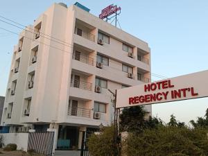 a hotel occupancy unit sign in front of a building at Hotel Regency International in Jamnagar