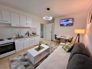 a living room with a couch and a kitchen at Central DELUXE Apartment in Prilep
