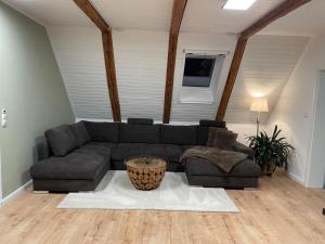 a living room with a couch and a table at Ferienhaus Alex - Wohnung im DG in Malliß