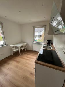 a kitchen with a sink and a counter top at Ferienhaus mit Trifelsblick in Annweiler am Trifels
