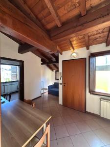 a living room with a wooden table and a couch at Dante 12 Flat in Cremona +10 photos