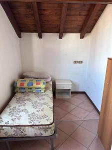 a room with two beds and a table in it at Dante 12 Flat in Cremona