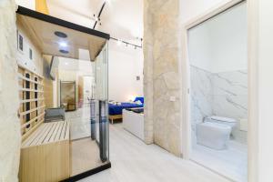 a bathroom with a glass door leading to a bedroom at Salerno Mare e Luci Suite in Salerno +36 photos