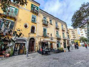 a building on a street with people walking on the street at Salerno Mare e Luci Suite in Salerno