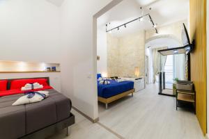 a bedroom with a large bed and a bathroom at Salerno Mare e Luci Suite in Salerno