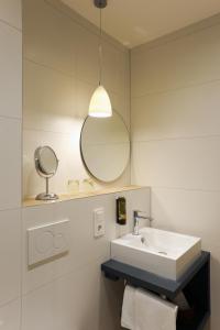 a bathroom with a sink and a mirror at Hotel Wilhelmshöhe Auderath in Auderath