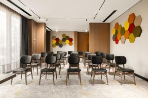 a conference room with chairs and paintings on the wall at Novotel Tbilisi Center in Tbilisi City +98 photos