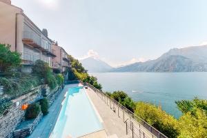 a swimming pool on the side of a building next to a body of water at Vista 180 by Halldis in Perledo
