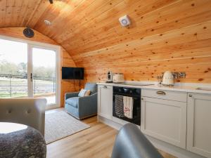 a kitchen and living room in a log cabin at Park View Lodge in Derby