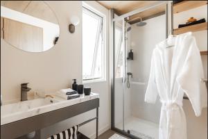 a bathroom with a sink and a shower at Campasun Camping de l'Aigle in Aiguines