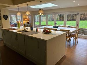 a kitchen with a large island in a kitchen with a table at Riverside Cottage in Marlborough