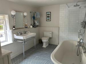 a bathroom with a tub and a toilet and a sink at Riverside Cottage in Marlborough +18 photos