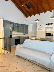a large kitchen with a white couch in a room at Varenna Boulevard in Varenna