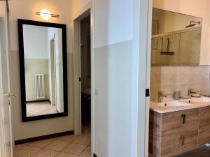 a bathroom with a sink and a mirror at Varenna Boulevard in Varenna +4 photos