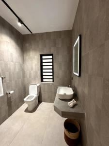a bathroom with a toilet and a sink at Green Heaven Studio in Bois Chéri +14 photos