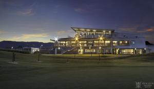 a large building with a golf course at night at Green Heaven Studio in Bois Chéri