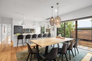 a kitchen and dining room with a wooden table and chairs at Guesthouse on Grampian in Cowes