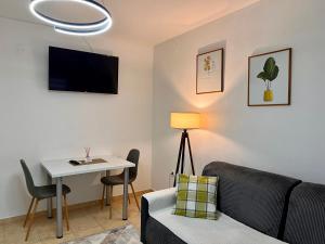a living room with a couch and a table at Central DELUXE Apartment in Prilep