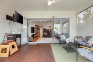 a living room with a couch and a table at Guesthouse on Grampian in Cowes