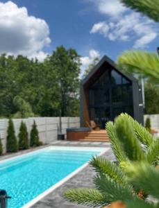 a swimming pool in front of a house at Chill House Dnipro in Dnipro +13 photos