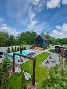 a backyard with a swimming pool and a house at Chill House Dnipro in Dnipro