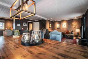 a living room with a table and a couch at Harmony in Geilo, modern and cozy cabin in Geilo