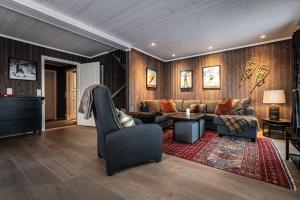 a living room with a couch and a table at Harmony in Geilo, modern and cozy cabin in Geilo