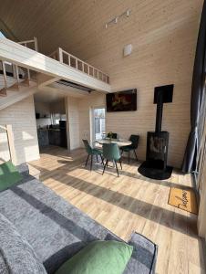 a room with a bed and a living room with a fireplace at Chill House Dnipro in Dnipro