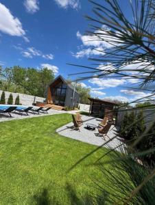 a backyard with chairs and a house at Chill House Dnipro in Dnipro