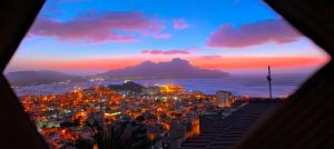a view of a city at night with a mountain at Hotel Belvedere Mindelo, Cabo Verde in Mindelo