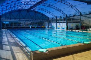a large swimming pool in a large building at Guest House San Domenico in Augusta