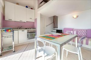 a kitchen with a table and chairs in a room at Villa K1- INFINITYHOLIDAYS in Costa Paradiso