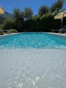a large blue swimming pool with blue water at Villa Gaia Apartments pool wifi parking in Malcesine